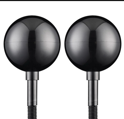 Two metallic spherical objects on cylindrical stands against a white background